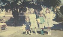 The Easter picture shows the four of us on Easter '62, standing in the middle of the court.  The front houses behind us are on Hudson. Both photos are taken from the same viewpoint. Where we're standing is where Gracia used to sit with little Jack.